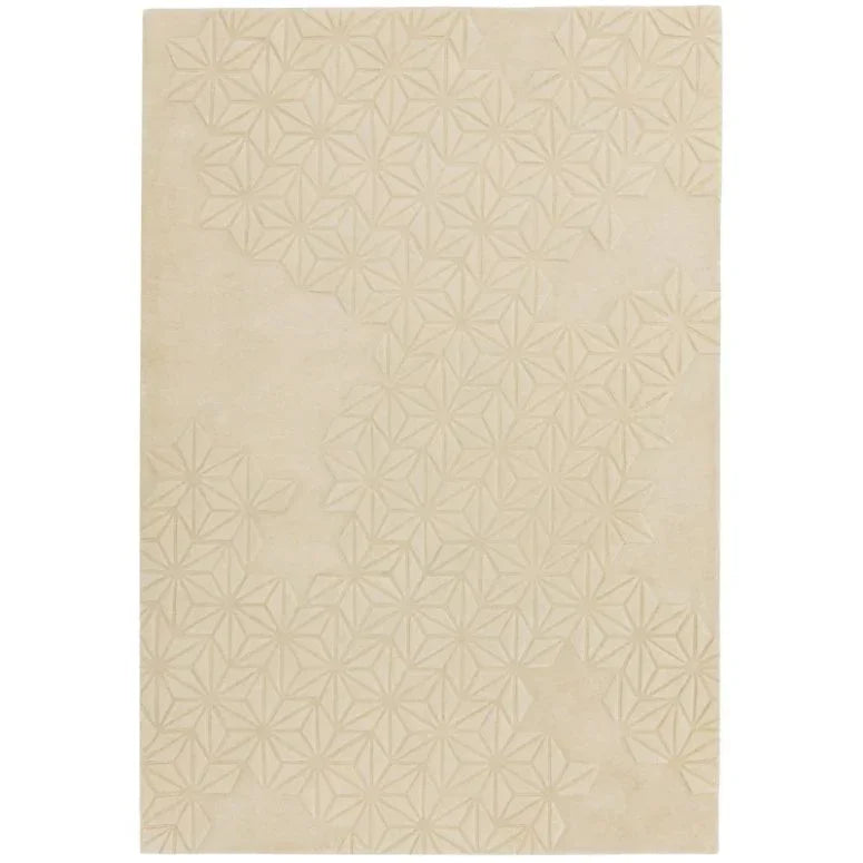 Beige area rug with subtle embossed geometric floral pattern, rectangular shape