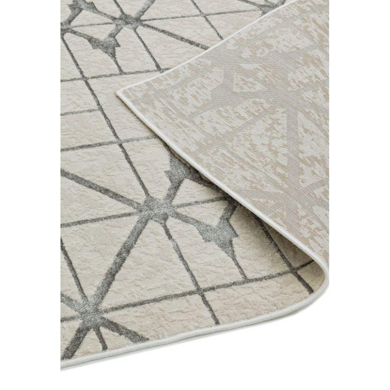 Beige geometric area rug with grey lines and corner folded to show backing detail