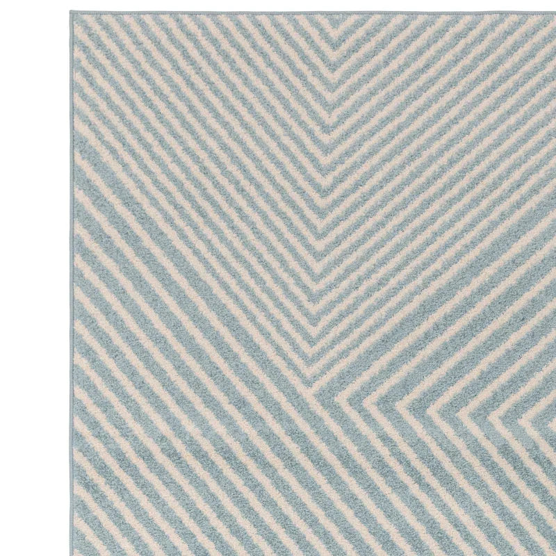 Chevron patterned rug with blue and cream stripes, close-up of textured fabric