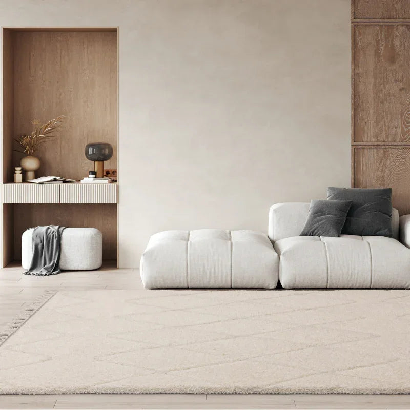 Modern white corner sofa with grey cushions in minimalist living room with light rug