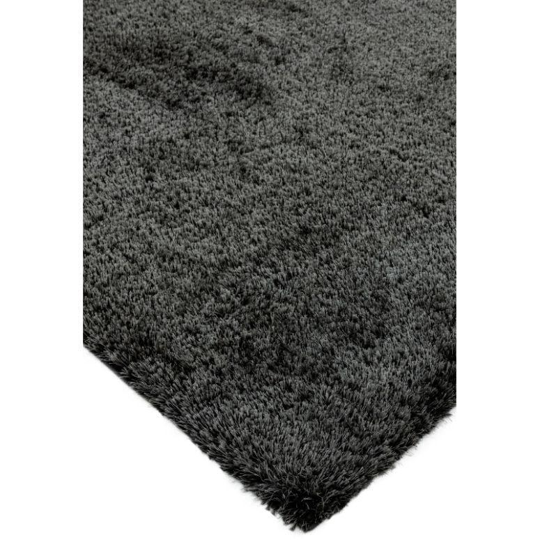 Charcoal grey shaggy rug corner with soft, thick pile texture