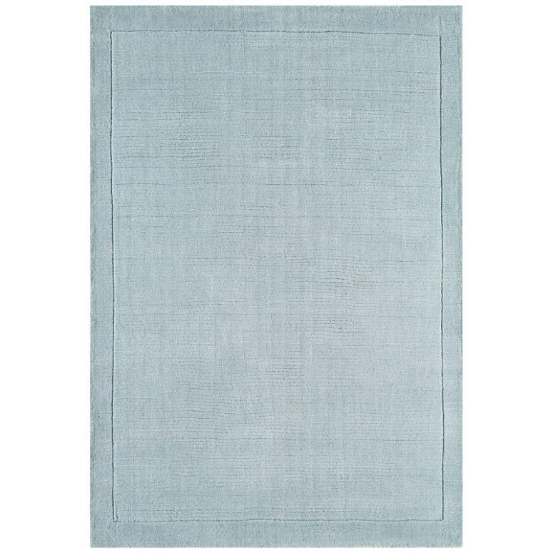 Light blue area rug with subtle textured border, rectangular, modern home decor accent