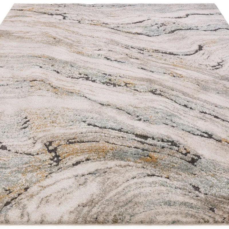 Abstract area rug with grey, cream, and gold marble pattern, angled front view
