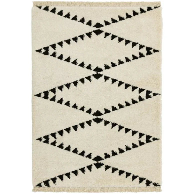 Cream area rug with black geometric zigzag pattern and fringe edges