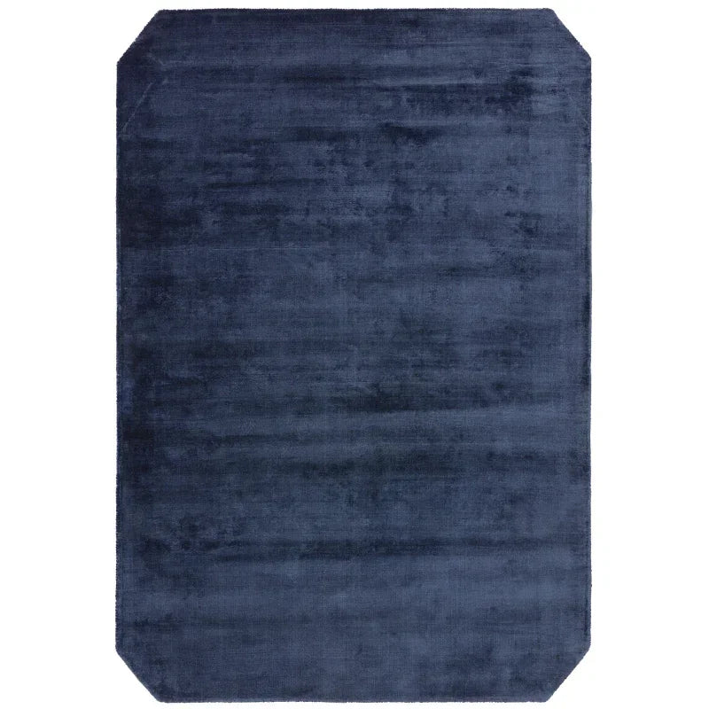 navy blue rectangular rug with cut corners and soft textured finish