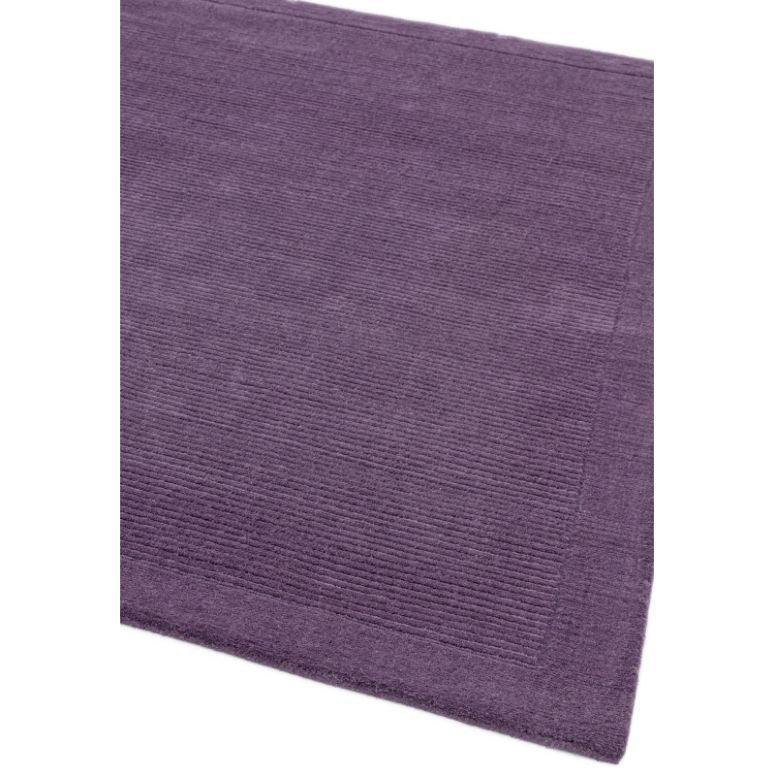 Plum purple area rug with subtle linear texture and border detail