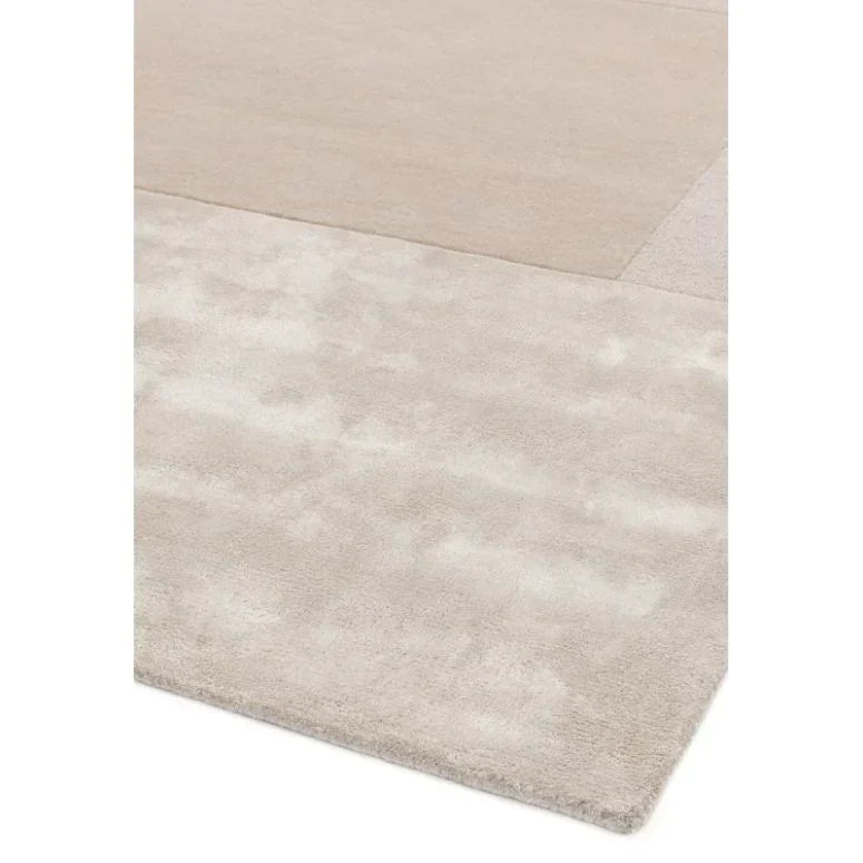 Modern beige area rug with subtle block pattern and soft texture, corner view