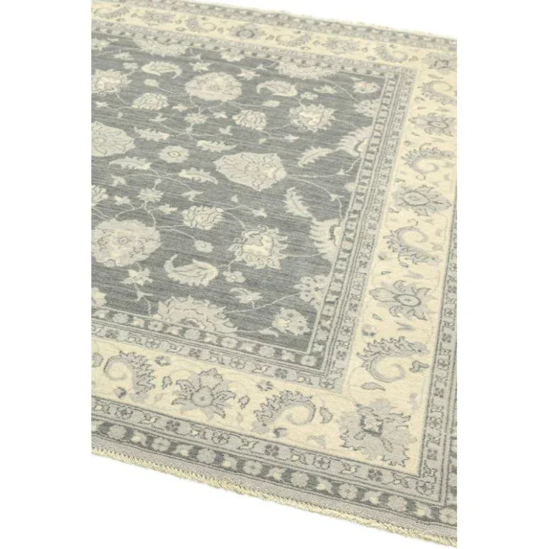 Grey and cream floral patterned rug with decorative border, corner angle view