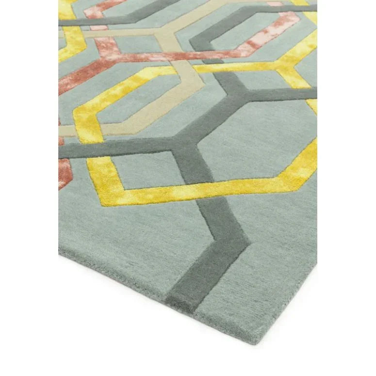 Contemporary area rug with yellow, grey, and coral geometric pattern on light grey background