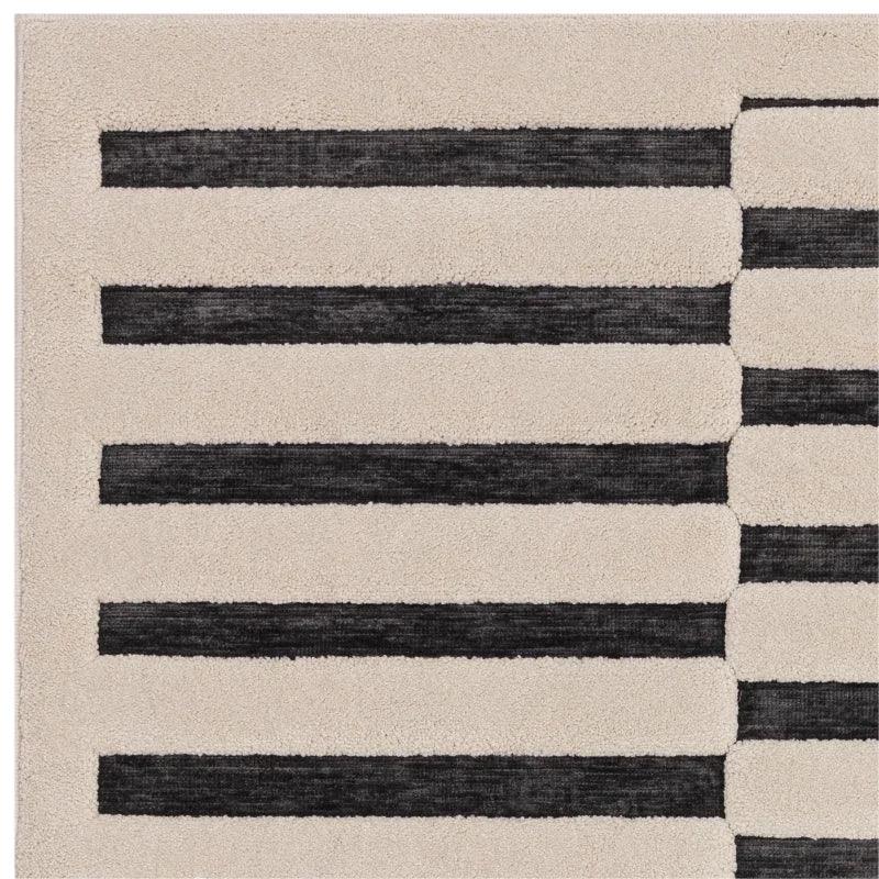 Beige and black striped rug with modern linear pattern, closeup of corner detail