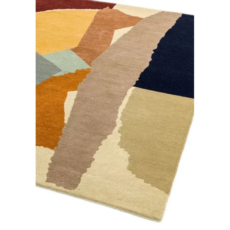 Modern area rug with bold abstract geometric color blocks in beige, navy, ochre, and brown