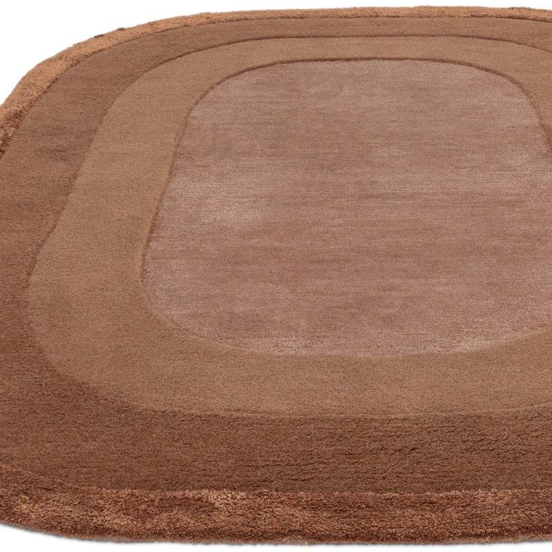 Brown area rug with curved rectangular design and plush texture