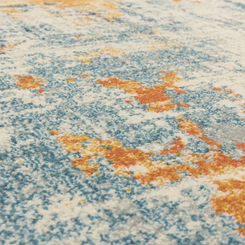 Close-up of blue and orange patterned rug texture with soft pile