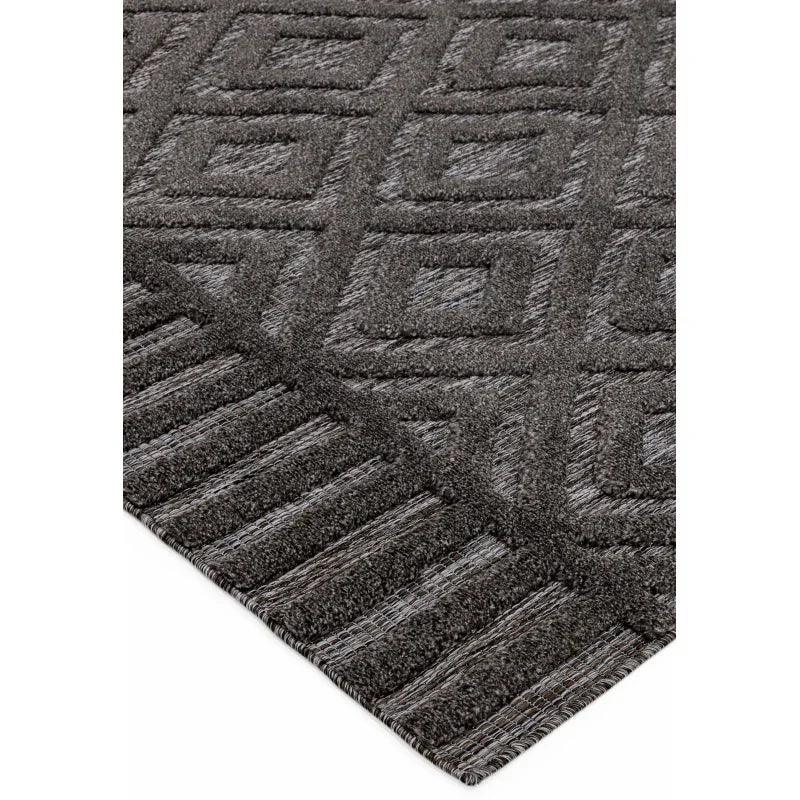 Charcoal grey geometric rug with raised textured diamond and striped border pattern
