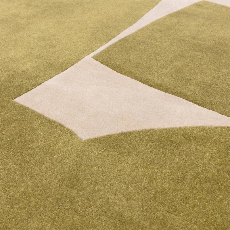 Green and beige geometric area rug with textured wool finish, close-up view