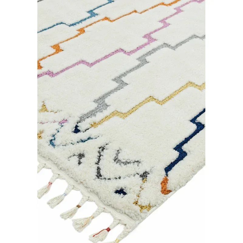 White shaggy rug with multicolour zigzag pattern and tasseled edge closeup