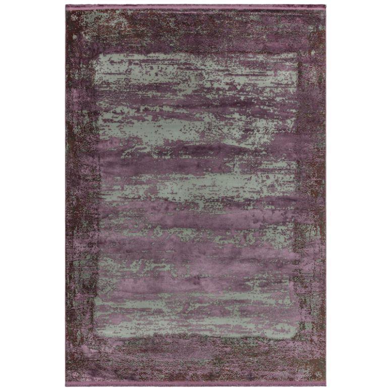 Purple and grey area rug with abstract distressed pattern and textured finish