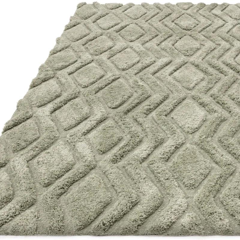 Light grey geometric patterned rug with raised textured design, angled corner view