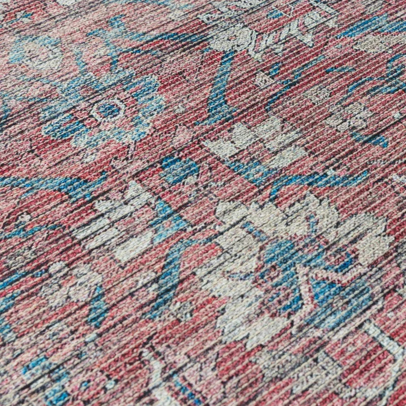 Red patterned area rug with blue and cream floral design and textured weave detail
