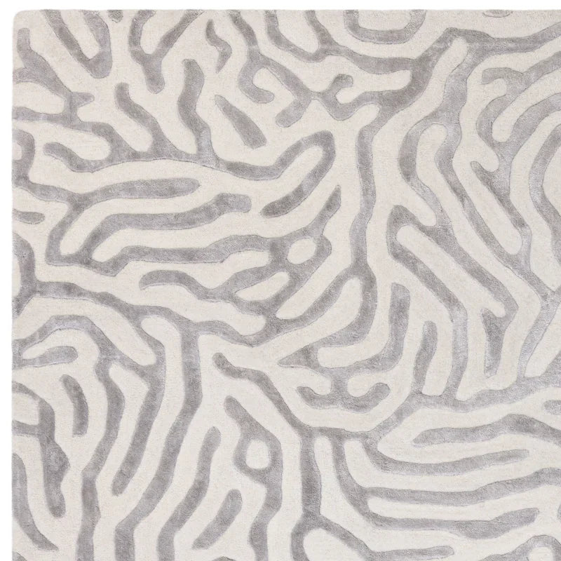 Grey and white patterned rug with abstract raised design, close-up view of texture