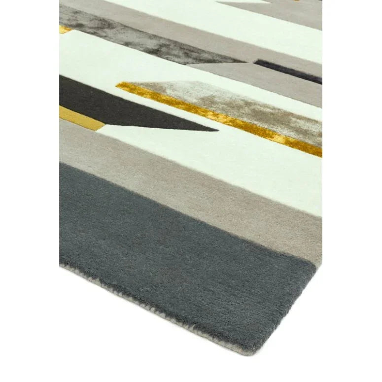 Modern geometric rug with grey, mustard, white, and taupe stripes, close corner view