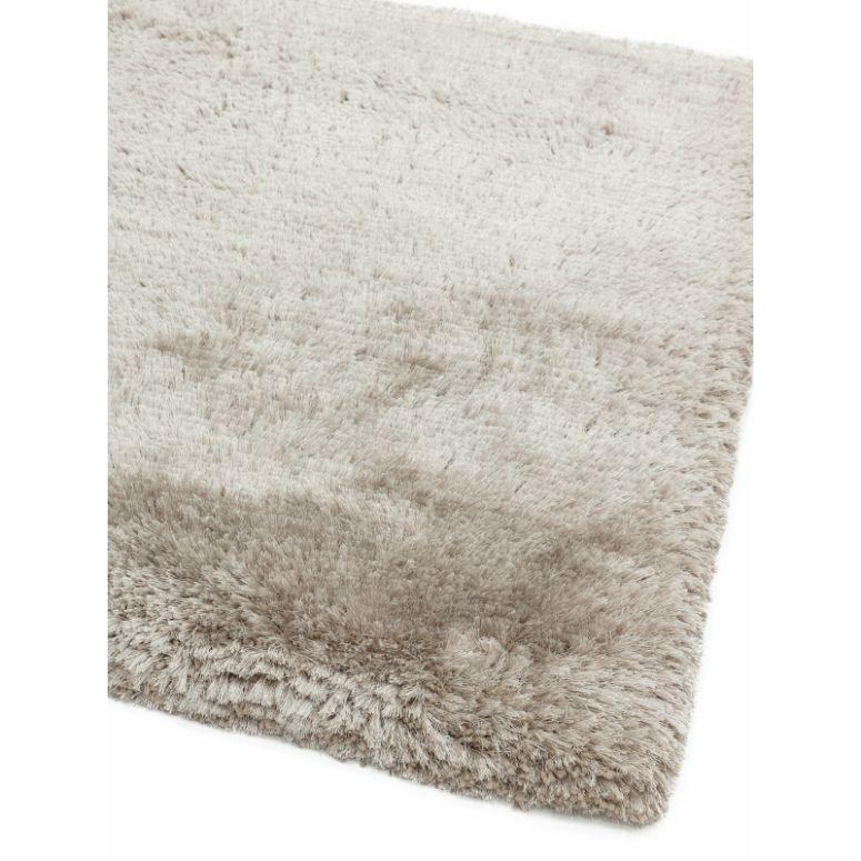 Close-up of light grey shaggy rug with thick, soft pile and plush texture