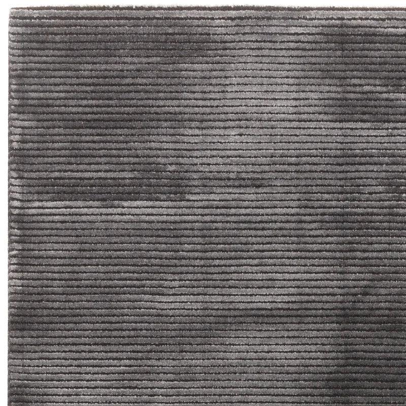 Grey textured rug with horizontal striped pattern, close-up of soft pile material