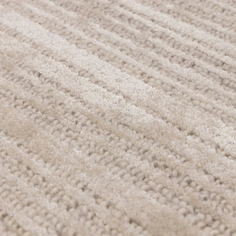 Textured cream wool rug closeup showing looped and plush weave pattern