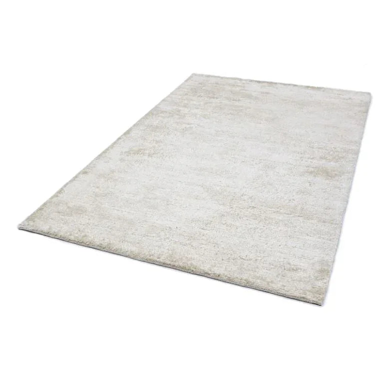 Rectangular cream area rug with soft textured finish, photographed from an angled view