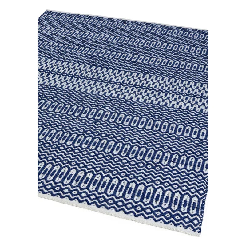 Blue and white patterned woven rug with geometric zigzag and oval design
