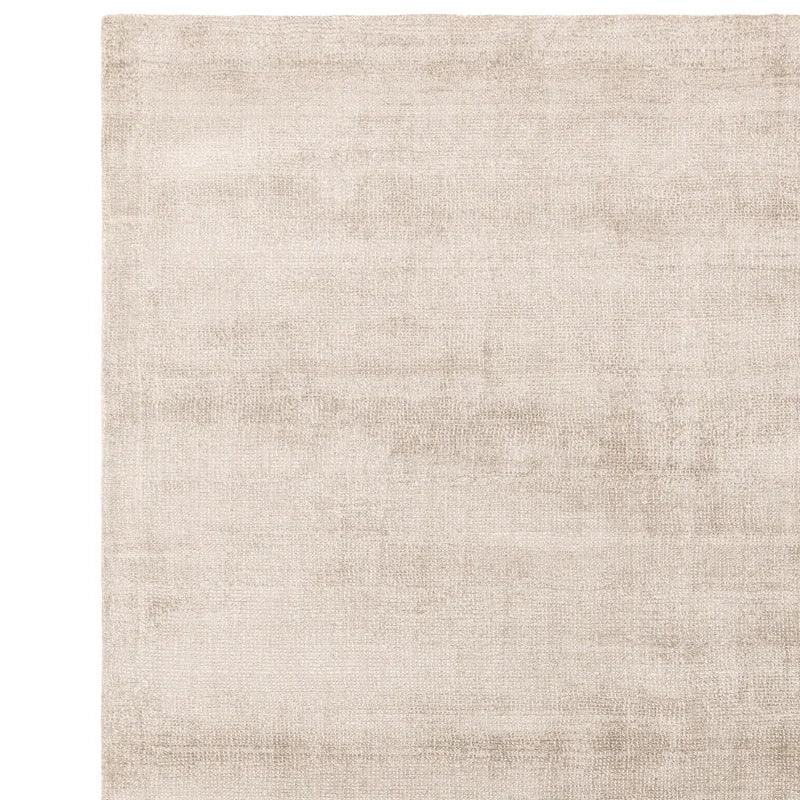 Beige area rug with subtle texture and soft finish, shown from above