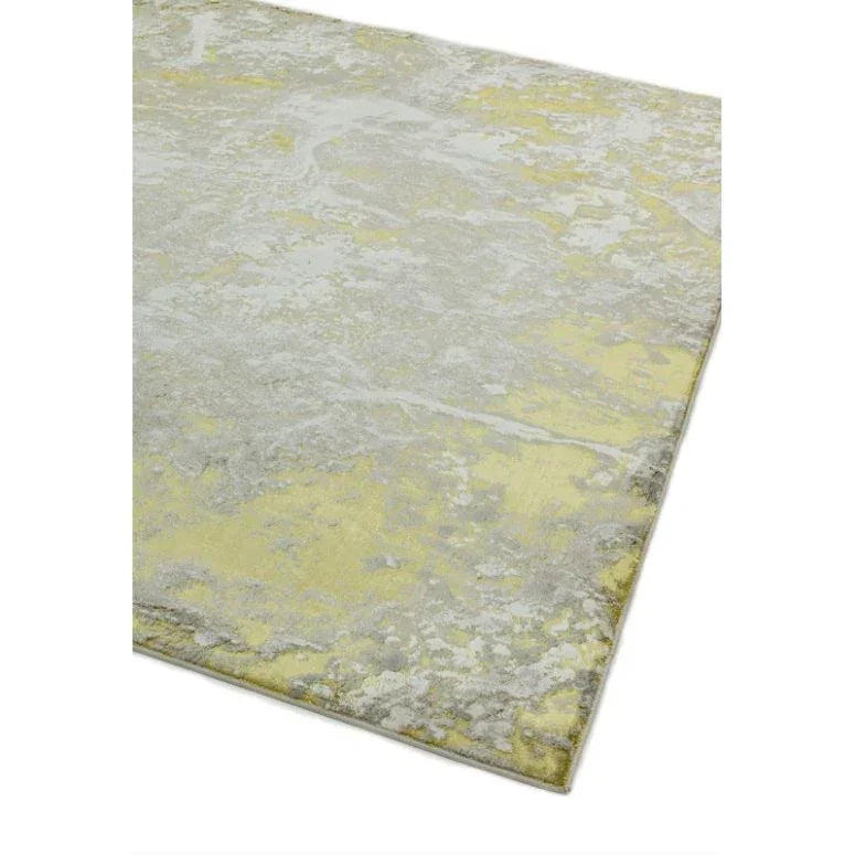 Abstract yellow and grey area rug with textured pattern, close-up of corner