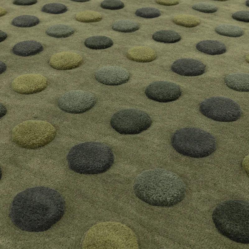 Green polka dot rug with raised textured circles in multiple shades of green