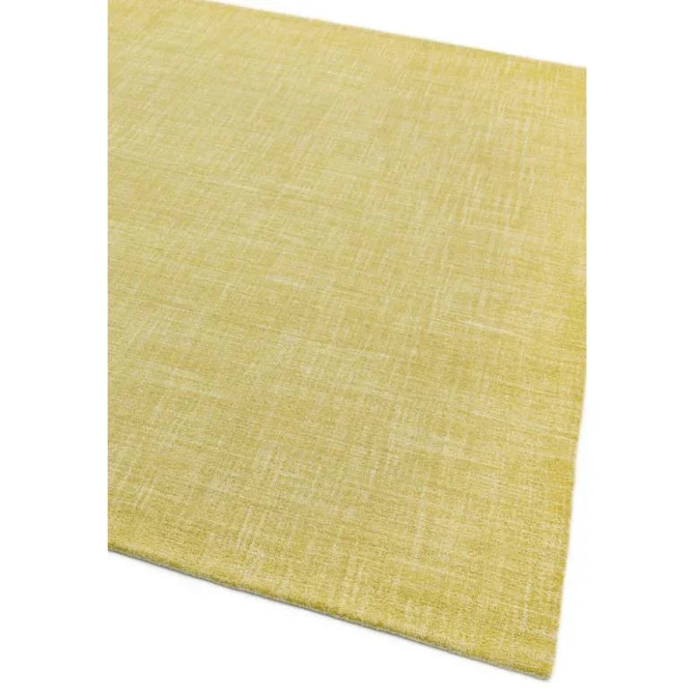 Yellow woven area rug with subtle textured pattern, corner detail shown
