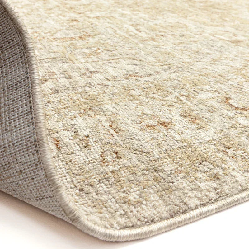 Beige patterned rug with textured surface and detailed edge close-up