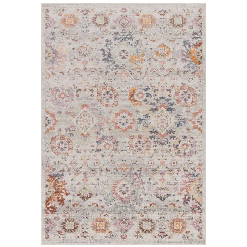 Traditional patterned area rug in muted cream, orange, and blue tones