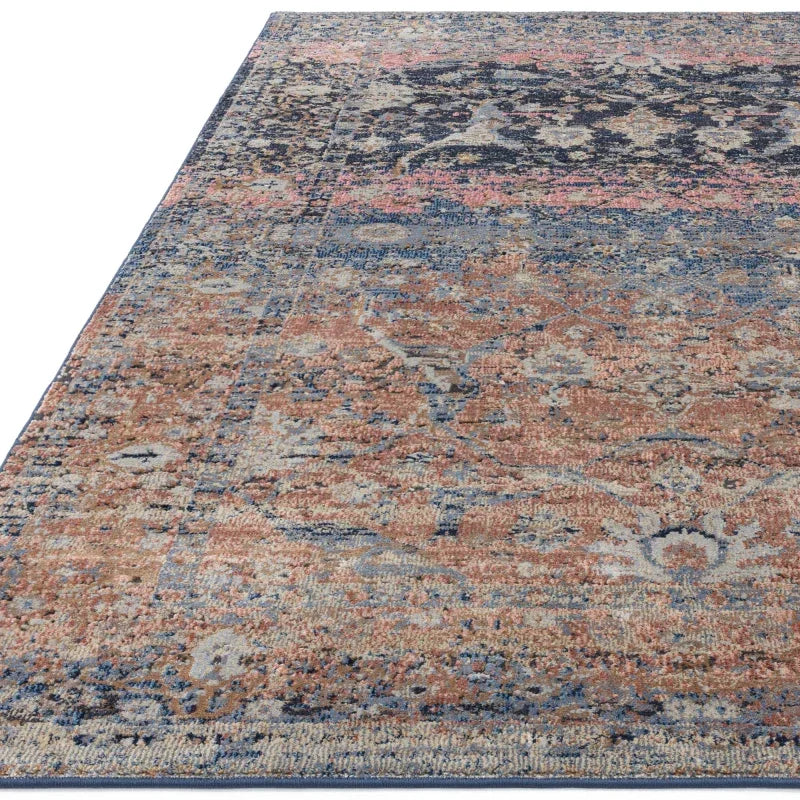 Vintage style rug with distressed blue, beige and terracotta pattern, corner view