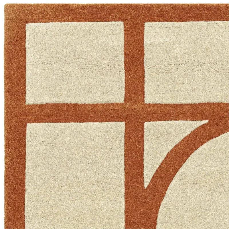 cream and rust geometric area rug with bold intersecting lines