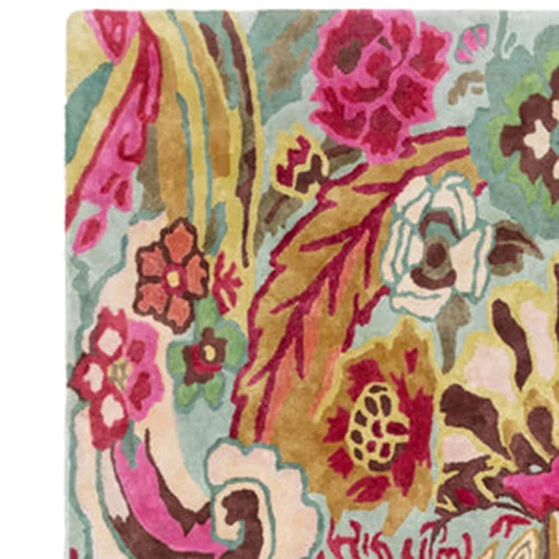Multicolor floral area rug with bold pink, yellow and green patterns on a light background