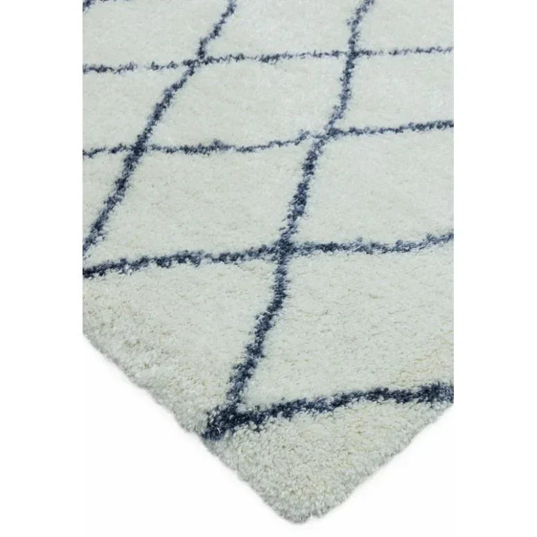 cream shaggy rug with black geometric grid pattern close-up corner view