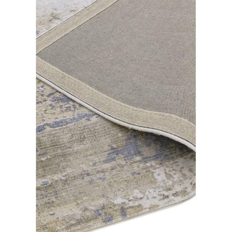Close-up of abstract patterned area rug with beige backing and blue grey accents