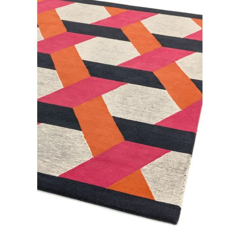 Modern geometric rug with pink, orange, black, and cream pattern, corner angle view