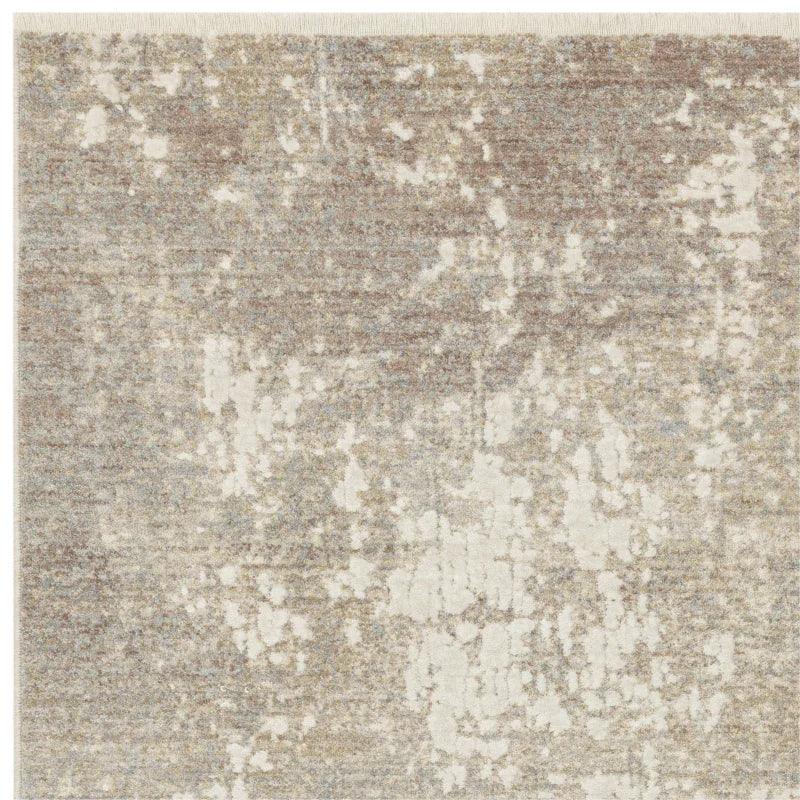 beige abstract area rug with distressed pattern and textured surface