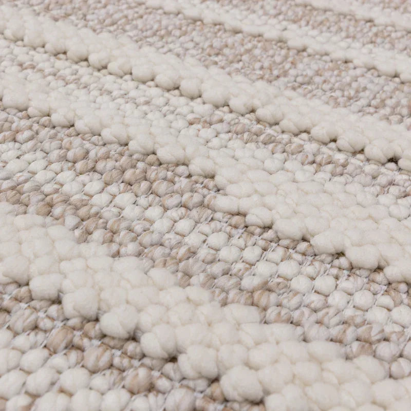 closeup of textured wool rug with beige and ivory striped weave