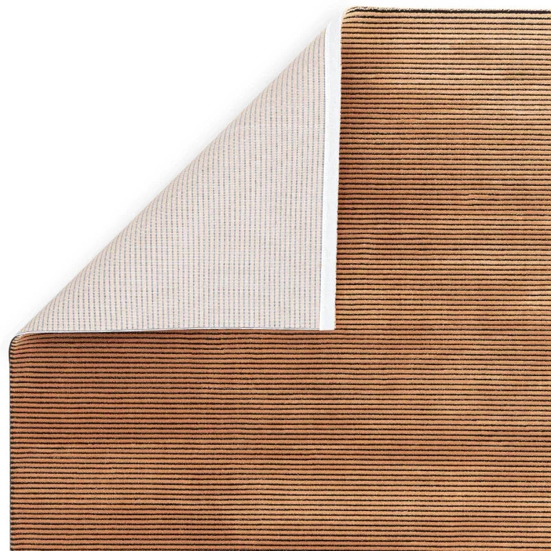 Brown striped area rug with corner flipped to show backing detail