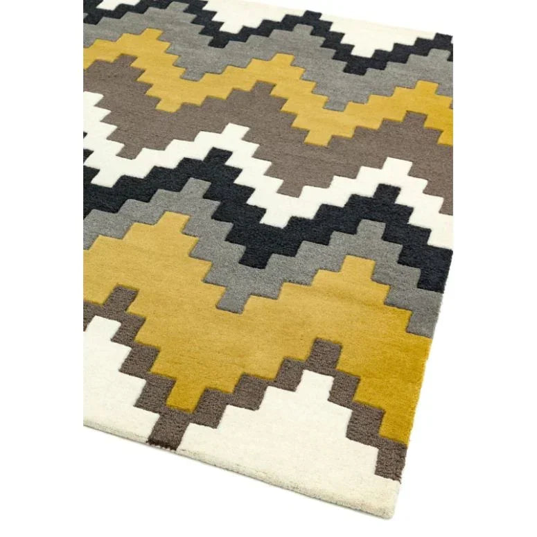 Geometric patterned rug with yellow, grey, black and white zigzag design