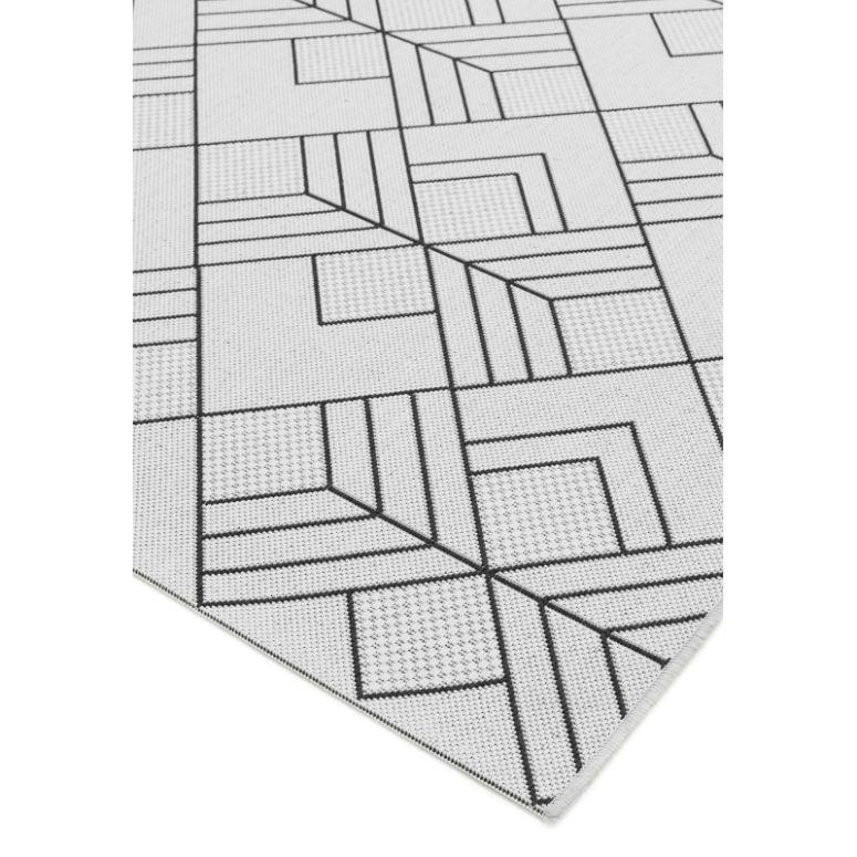 grey geometric rug with black linear pattern, close-up of corner and texture detail
