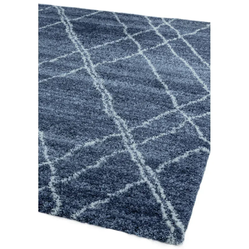 Blue shaggy rug with white crisscross pattern and soft textured pile shown at angle