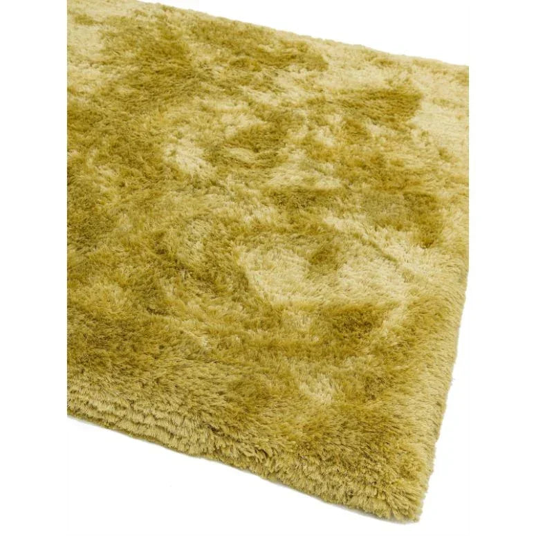 Shaggy yellow area rug with thick pile and subtle textured pattern, corner view