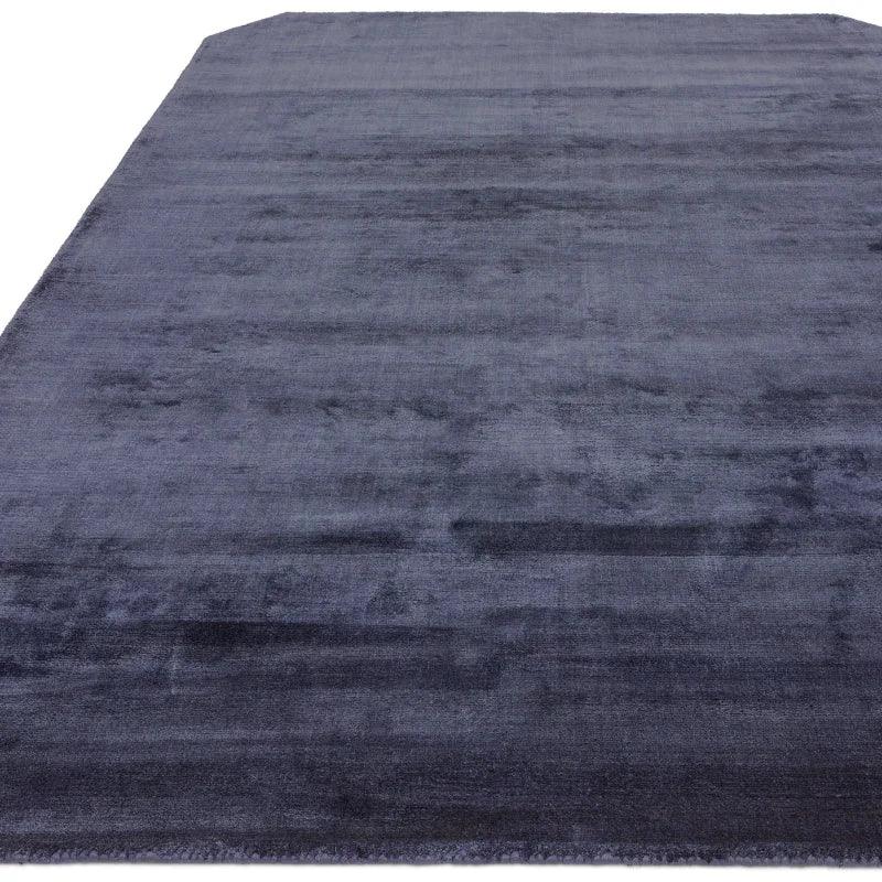 Rectangular dark grey area rug with subtle texture and soft finish